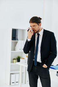 Full length of young man using smart phone