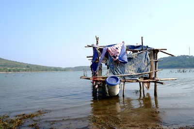 Ship in lake against clear sky