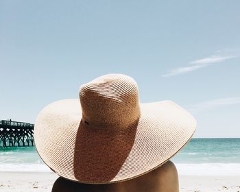 Rear view of person wearing sun hat at beach