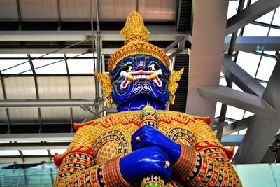 Low angle view of statue against temple building