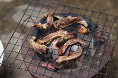High angle view of meat on barbecue grill