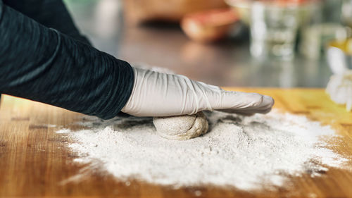 Chef's hand making dough in a restaurant
