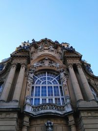 Low angle view of building against clear blue sky