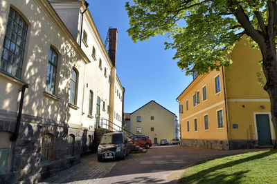 Cars on street amidst buildings in city