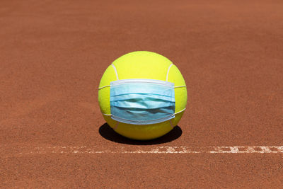 Close-up of yellow ball on beach