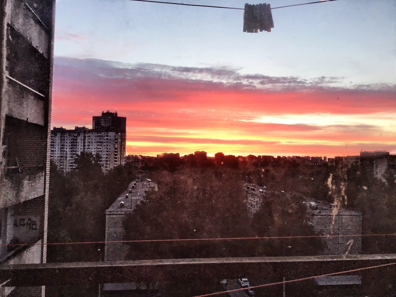 BUILDINGS IN CITY AGAINST SKY AT SUNSET