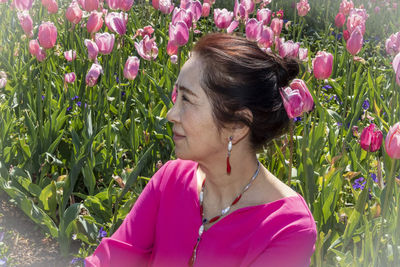 Portrait of woman with pink flower