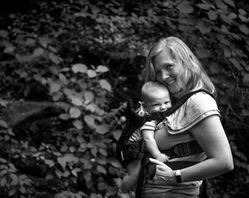 Portrait of mother and son against plants