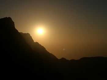 Scenic view of silhouette mountain against sky during sunset