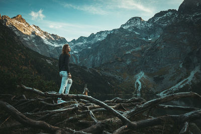 Full length of man standing on rock against sky