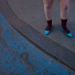Low section of woman standing on tiled floor