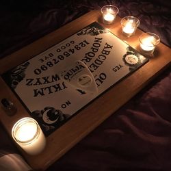 Close-up of illuminated candle on table