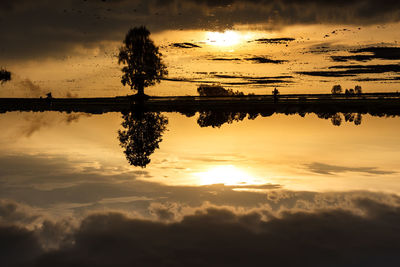 Scenic view of lake against sky during sunset