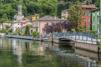 Arch bridge over river against buildings