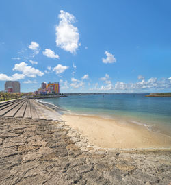 Beach coast lined with palm trees of distortion seaside and oak fashion buildings in okinawa.