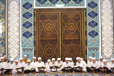 Group of people in traditional temple against building