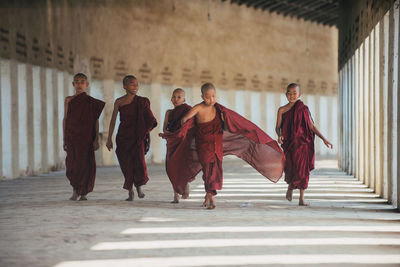 Group of people walking in corridor of building