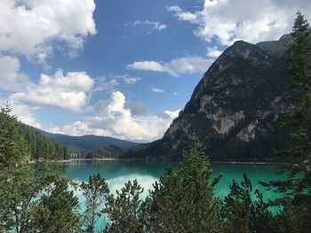 Scenic view of lake by mountains against sky