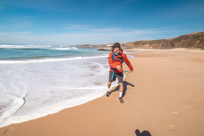 Full length of woman walking at beach