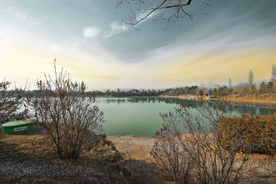 Scenic view of river against sky at sunset