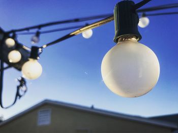 Low angle view of light bulb against clear sky