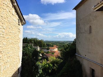 Houses in town against sky