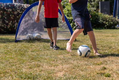 Low section of man playing soccer on field
