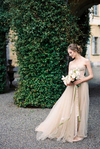 Full length of bride standing in park