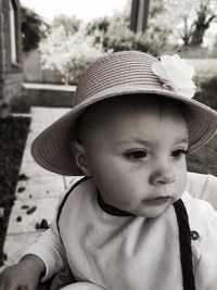 Close-up of cute boy sitting outdoors