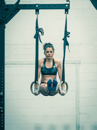 Full length of woman exercising in gym