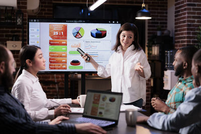 Businesswoman giving presentation in office