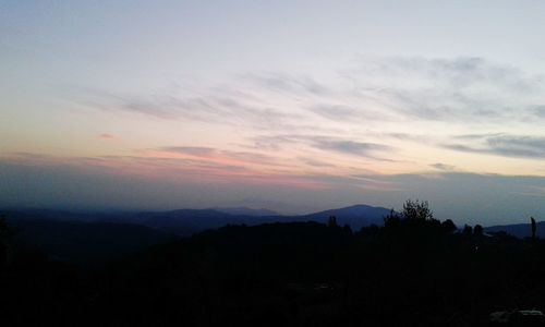 Scenic view of mountains against sky at sunset