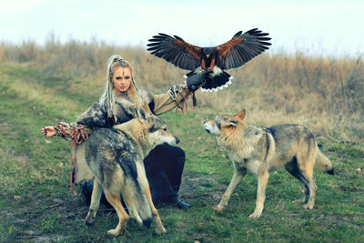 Portrait of woman with animals in forest