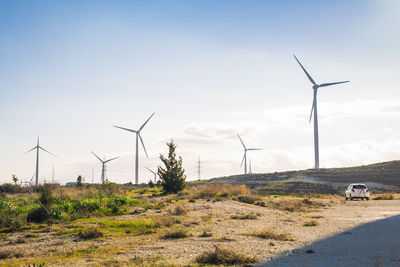 Windmill on field against sky