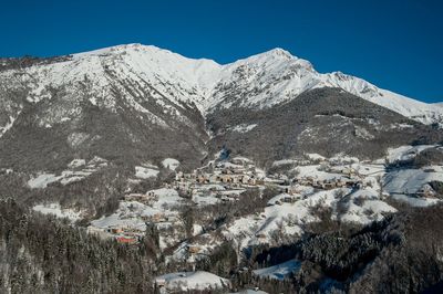 Scenic view of snowcapped mountains against clear sky