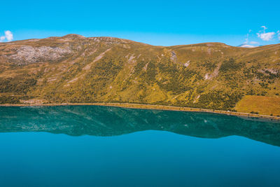 View of lake by mountain against sky