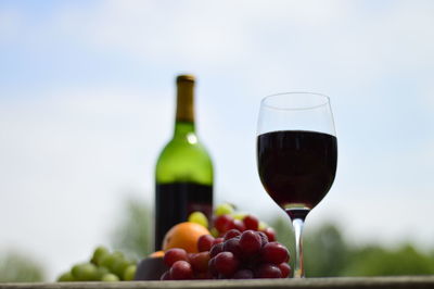 Low angle view of wineglass and grapes on table