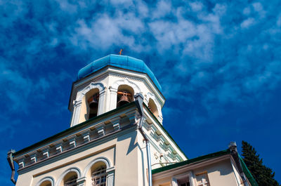 Low angle view of church against cloudy sky