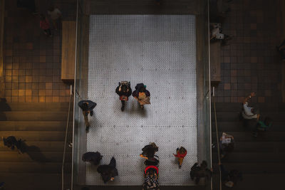 High angle view of people walking on footpath at night