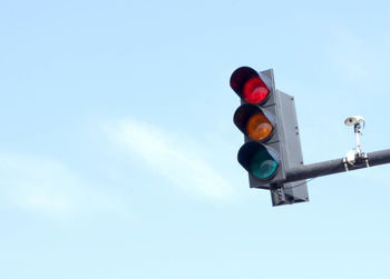 Low angle view of road signal against sky