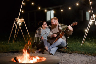 People playing guitar at music concert