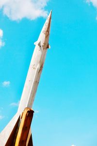 Low angle view of rocket against blue sky