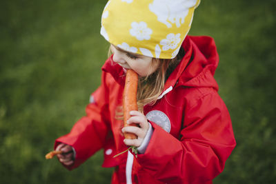 Girl eating carrot