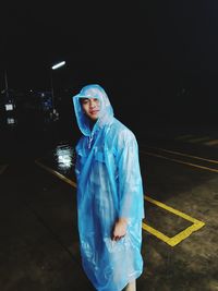 Portrait of young man standing at night