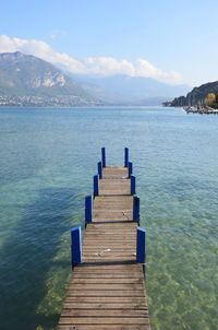 Pier over sea against blue sky