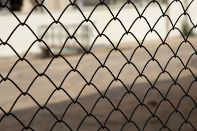 Close-up of chainlink fence against sky