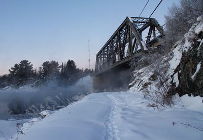 Low angle view of bridge against sky during winter