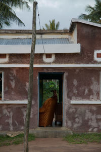 Rear view of woman walking outside building