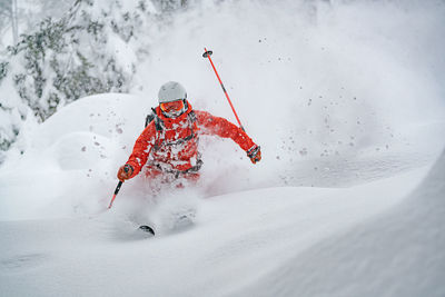 Adult man skiing in deep powder snow in the backcountry, werfenweng, austria
