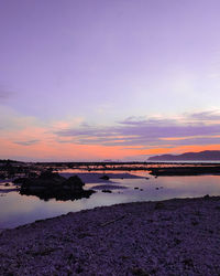 Scenic view of beach against sky during sunset